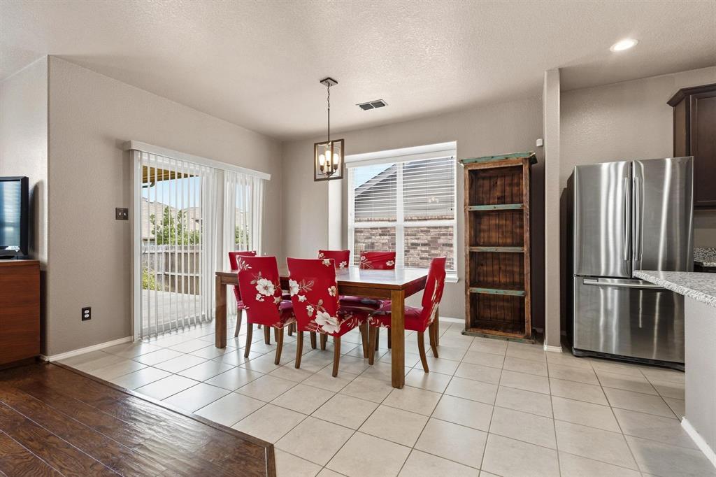 5513 Wharfside Place Denton, TX 76208 - Photo 11 of 37 a view of a dining room with furniture window and wooden floor