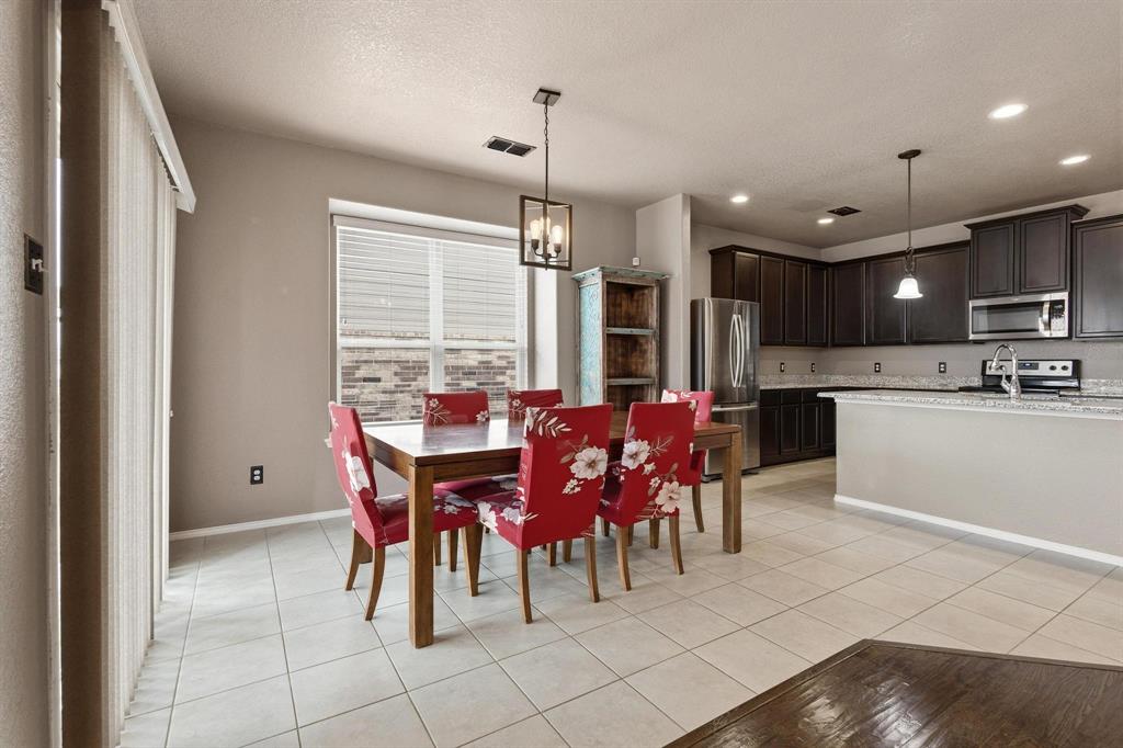 5513 Wharfside Place Denton, TX 76208 - Photo 12 of 37 a view of a dining room with furniture
