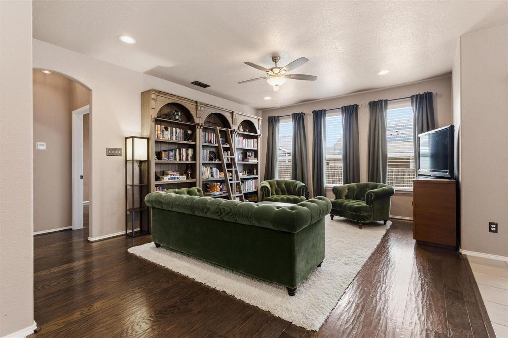 5513 Wharfside Place Denton, TX 76208 - Photo 14 of 37 a living room with furniture and a flat screen tv