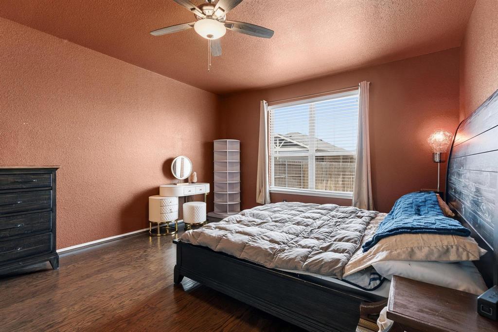 5513 Wharfside Place Denton, TX 76208 - Photo 25 of 37 a bedroom with a bed and a chandelier