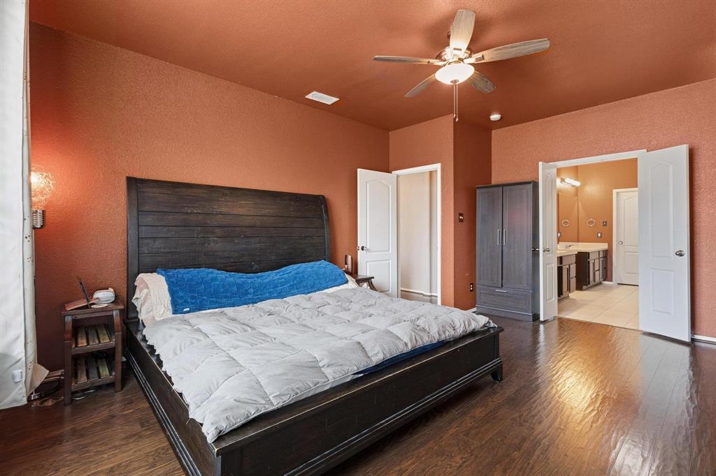 5513 Wharfside Place Denton, TX 76208 - Photo 27 of 37 a bedroom with a bed and a chandelier