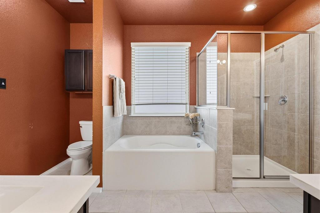 5513 Wharfside Place Denton, TX 76208 - Photo 30 of 37 a white bath tub sitting next to a white toilet