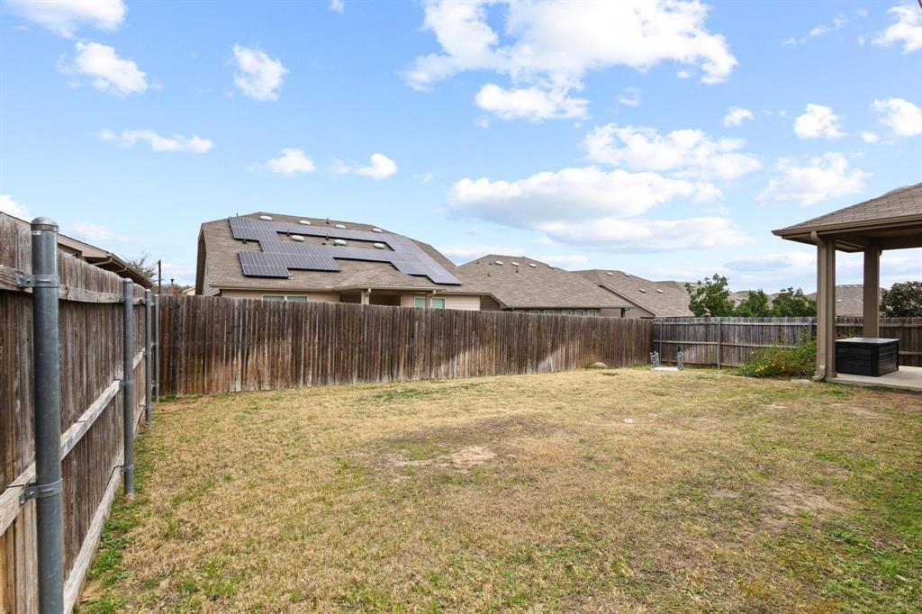 5513 Wharfside Place Denton, TX 76208 - Photo 34 of 37 a backyard of a house with table and chairs