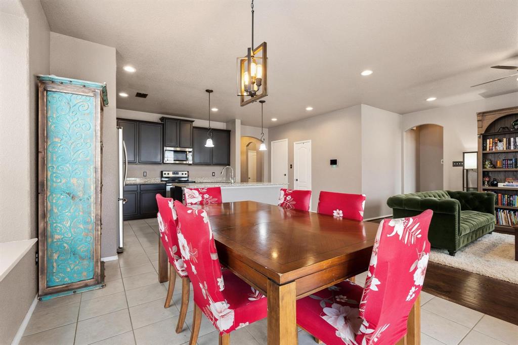 5513 Wharfside Place Denton, TX 76208 - Photo 10 of 37 a view of kitchen with stainless steel appliances kitchen island granite countertop a refrigerator dining table and chairs