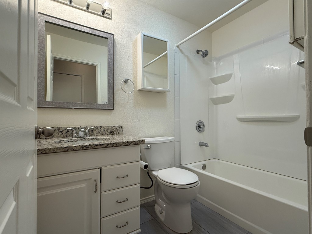 314 Raintree Drive Georgetown, TX 78626 - Photo 4 of 14 a bathroom with a granite countertop sink a toilet and shower