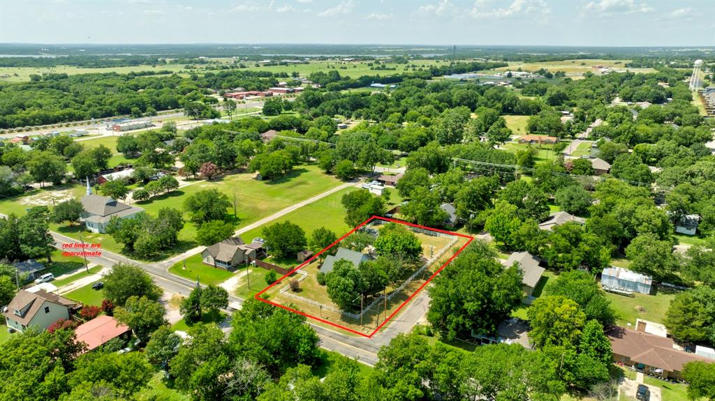 503 Sherman Street Tioga, TX 76271 - Photo 2 of 13 Expansive residential lot featuring mature trees and a single-story residence