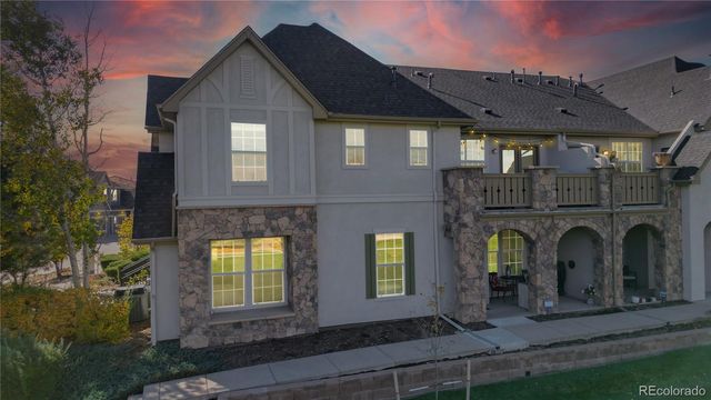 a front view of a house with glass windows and yard