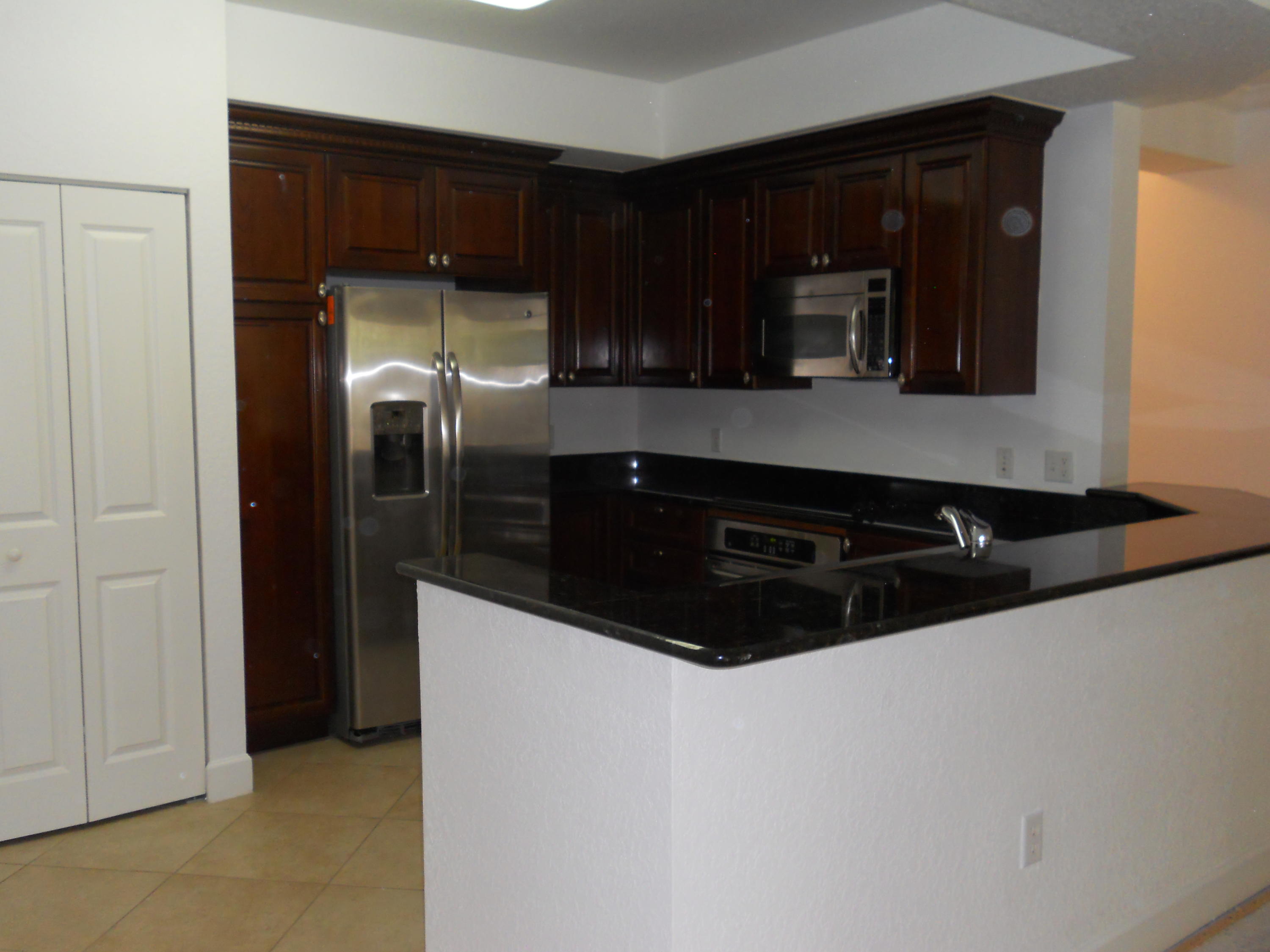 1102 Renaissance Way, Unit 102 Boynton Beach, FL 33426 - Photo 2 of 22 KITCHEN W/GRANITE COUNTERS