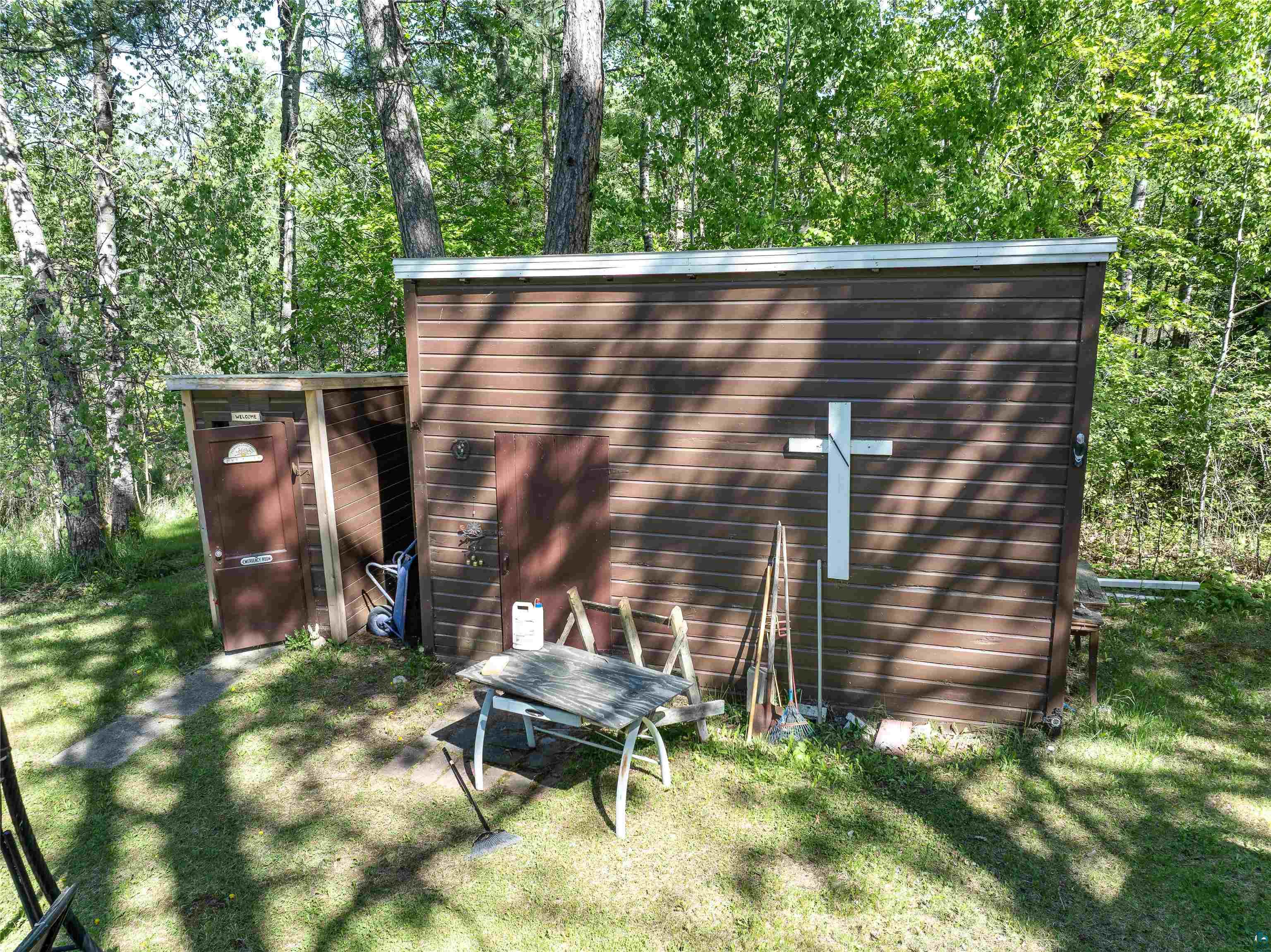 9064 Peppard Road Britt, MN 55710 - Photo 34 of 40 Brown horizontal siding structure with a white cross accent