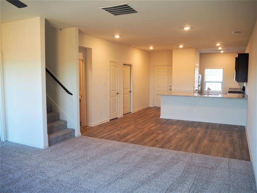 13612 Musselshell Drive Ponder, TX 76259 - Photo 11 of 39 a view of kitchen and hall with stainless steel appliances wooden floor