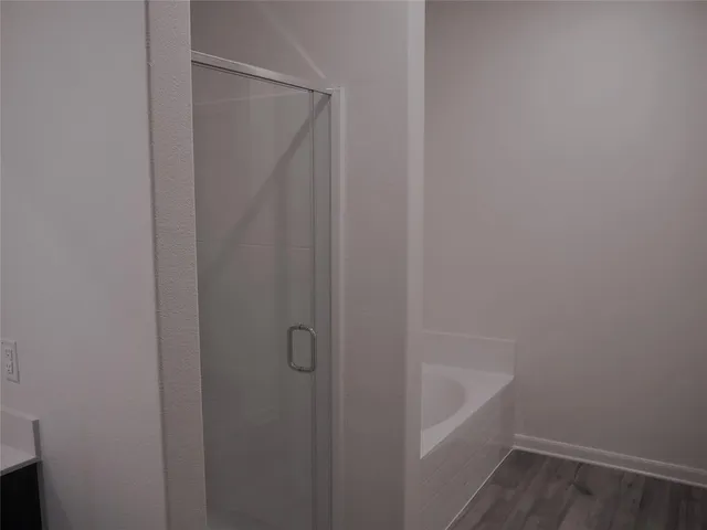 a bathroom with a shower and a sink