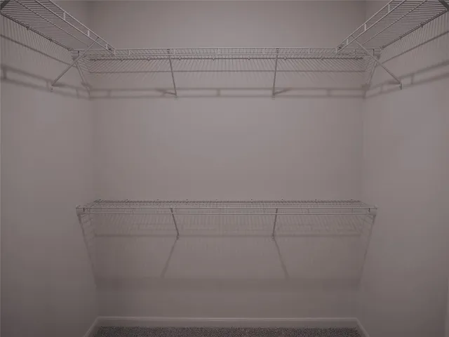 a view of hallway with wooden floor