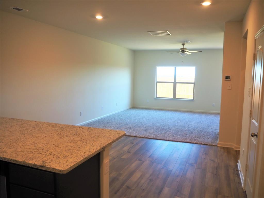 13612 Musselshell Drive Ponder, TX 76259 - Photo 8 of 39 an empty room with wooden floor and windows