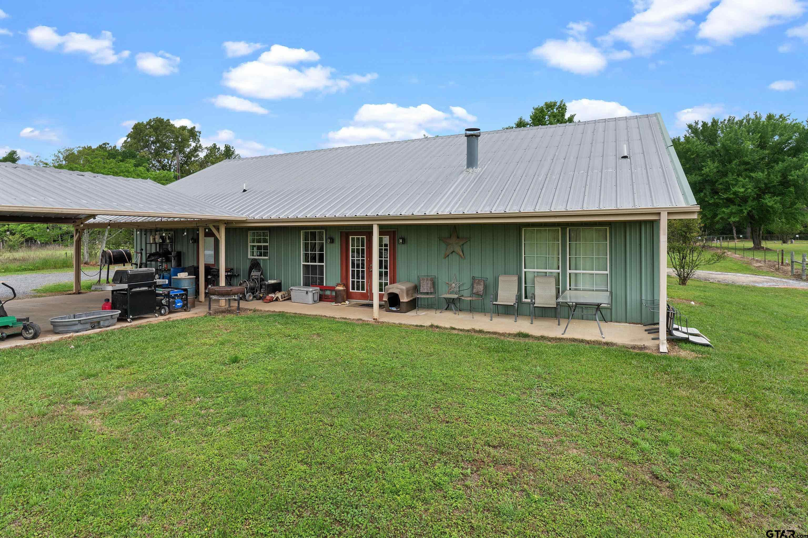 8550 New Hope Road Gilmer, TX 75645 - Photo 12 of 12 a view of a house with backyard porch and sitting area