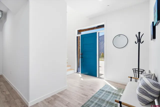 a view of a room with furniture and wooden floor