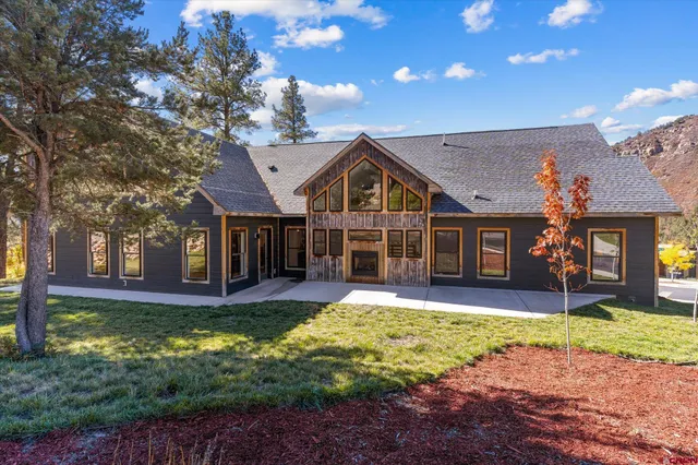 a front view of a house with a yard outdoor seating and yard