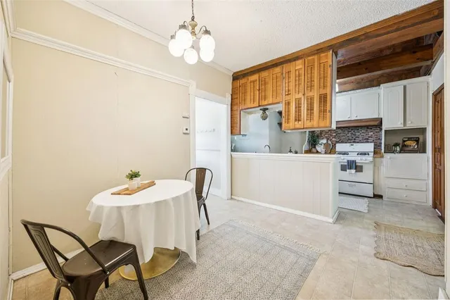 a view of a kitchen with a dining table chairs and a refrigerator