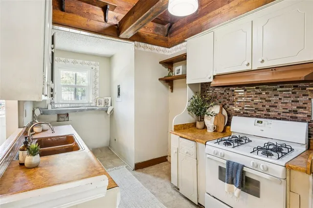 a kitchen with stainless steel appliances granite countertop a stove and a cabinets