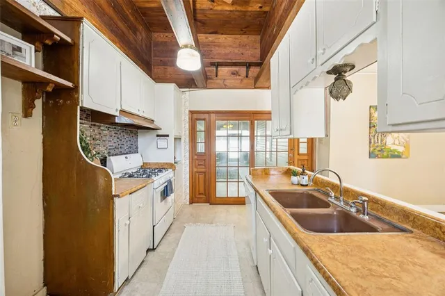 a kitchen with stainless steel appliances granite countertop a sink and a refrigerator
