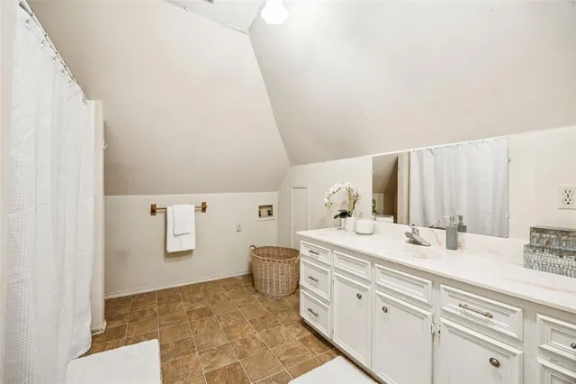 a spacious bathroom with a double vanity sink a mirror and a