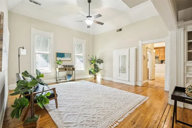 a large white room with wooden floor