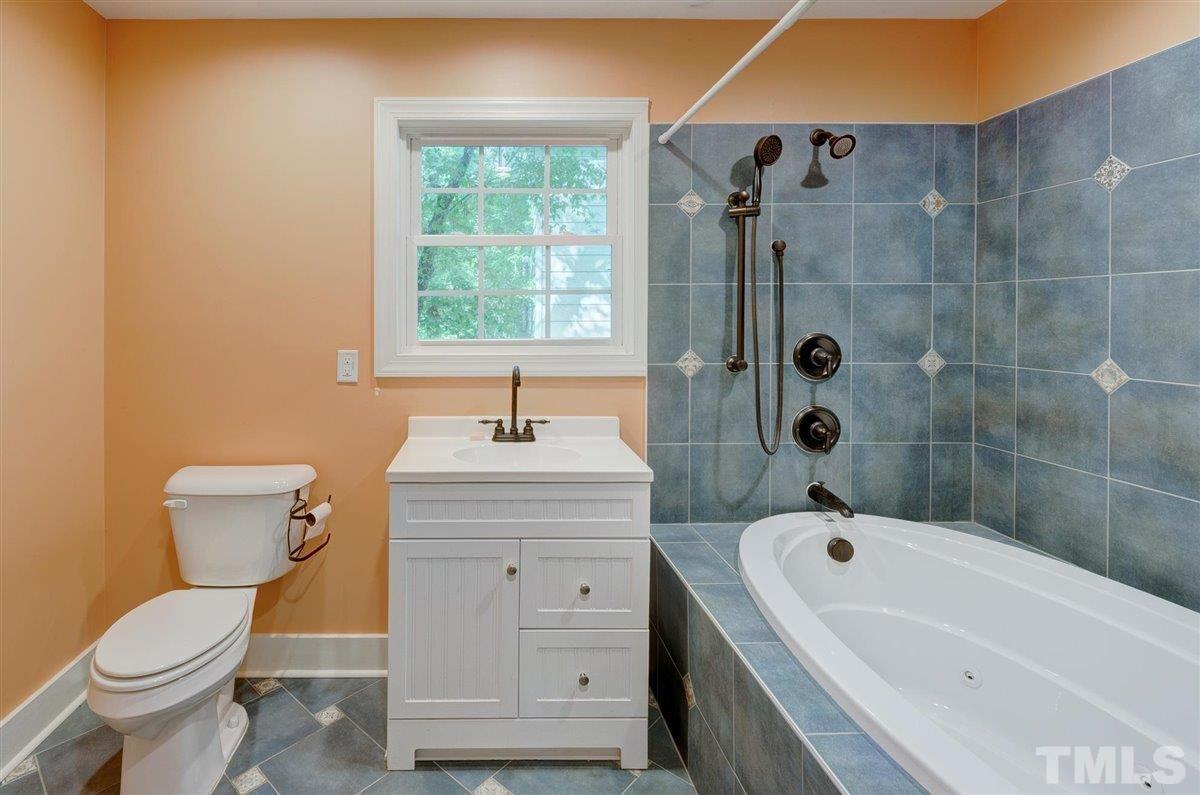 5816 Old Stage Road Raleigh, NC 27603 - Photo 12 of 30 a bathroom with a sink a toilet and shower