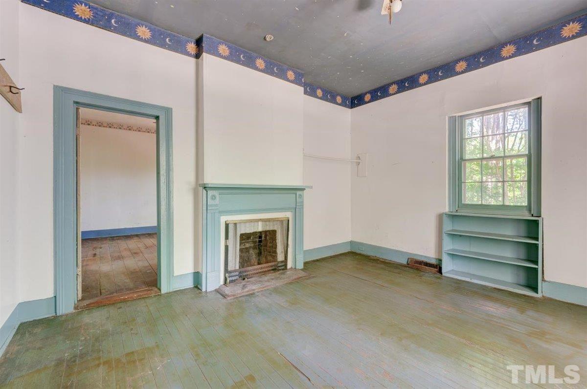 5816 Old Stage Road Raleigh, NC 27603 - Photo 14 of 30 a view of an empty room with a fireplace and a window