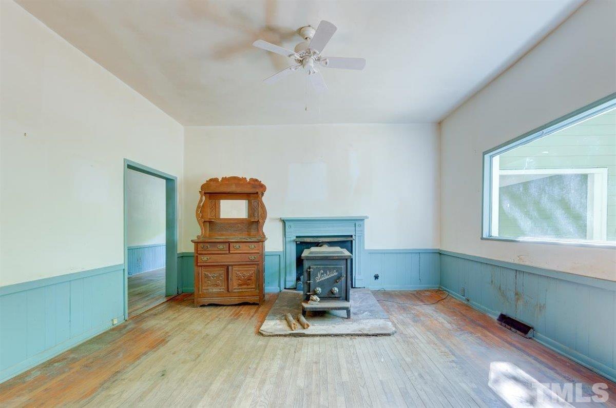 5816 Old Stage Road Raleigh, NC 27603 - Photo 21 of 30 a living room with hard wood floors and a ceiling fan
