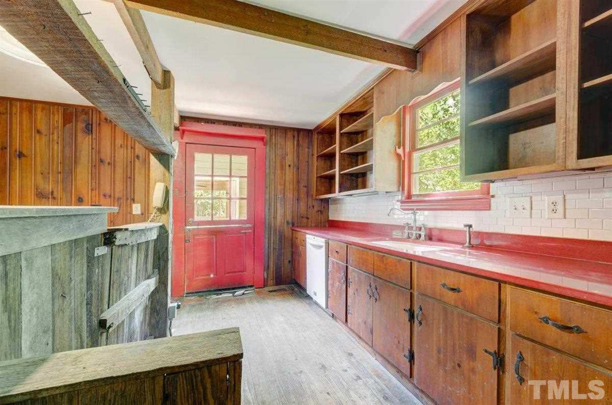 5816 Old Stage Road Raleigh, NC 27603 - Photo 24 of 30 a kitchen with sink cabinets and window