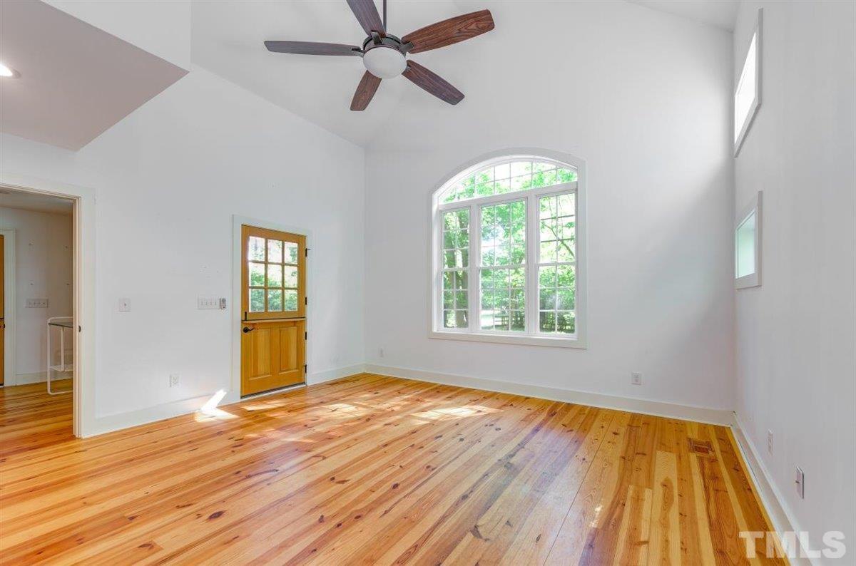 5816 Old Stage Road Raleigh, NC 27603 - Photo 6 of 30 a view of empty room with wooden floor and fan