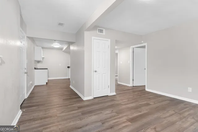 a view of a hallway with wooden floor