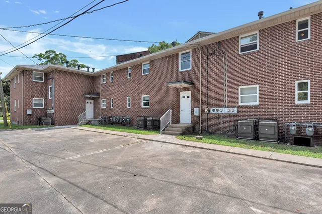 a front view of a house with a garden and a garage