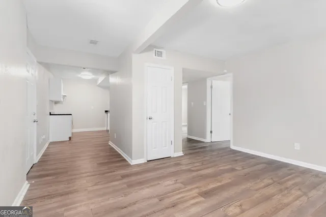 a view of a hallway with wooden floor