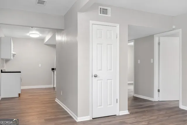 a view of a hallway with wooden floor