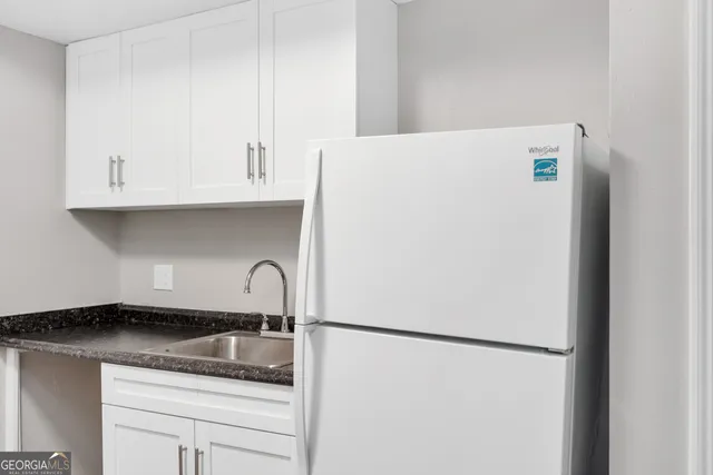 a white refrigerator freezer sitting inside of a kitchen