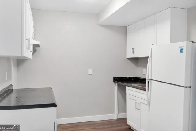 a kitchen with cabinets and stainless steel appliances
