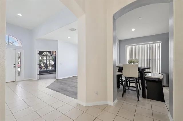 a kitchen with cabinets and chairs