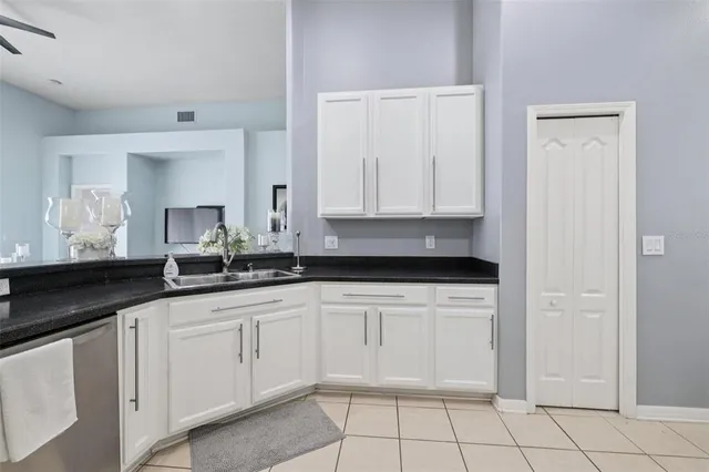 a kitchen with cabinets stainless steel appliances and a window