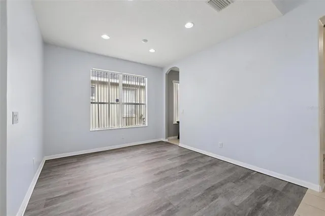 a view of a room with wooden floor