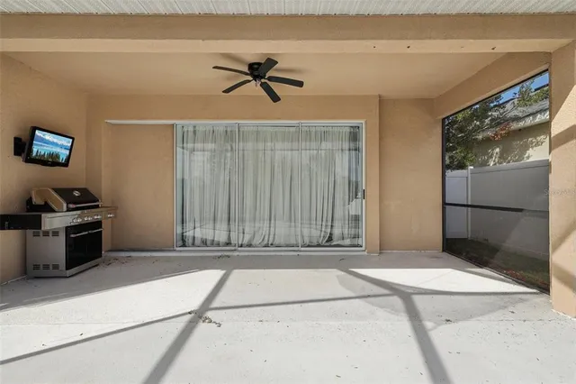 a view of an house with backyard and a tree