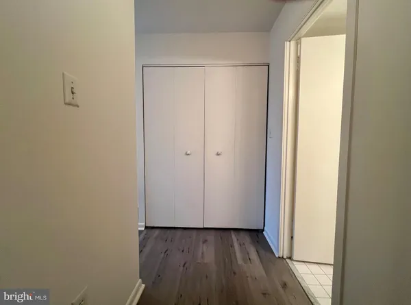 a view of a room with wooden floor