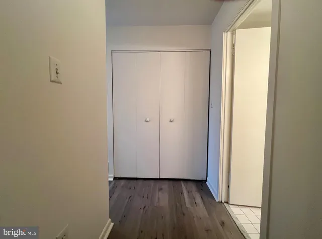 a view of a room with wooden floor