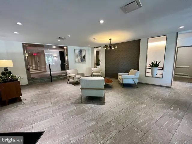 a lobby with furniture and stairs