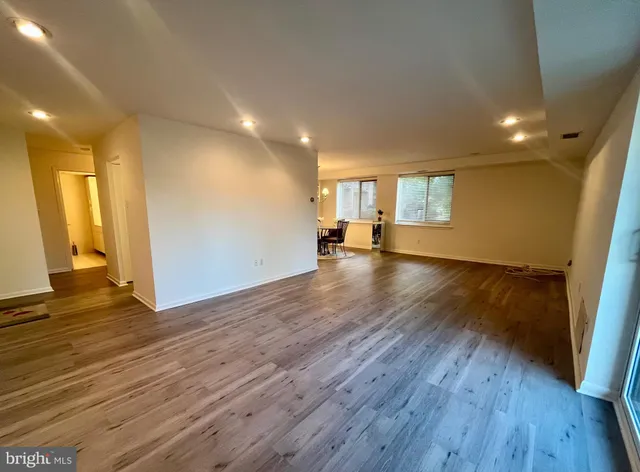 a view of a room with wooden floor and window
