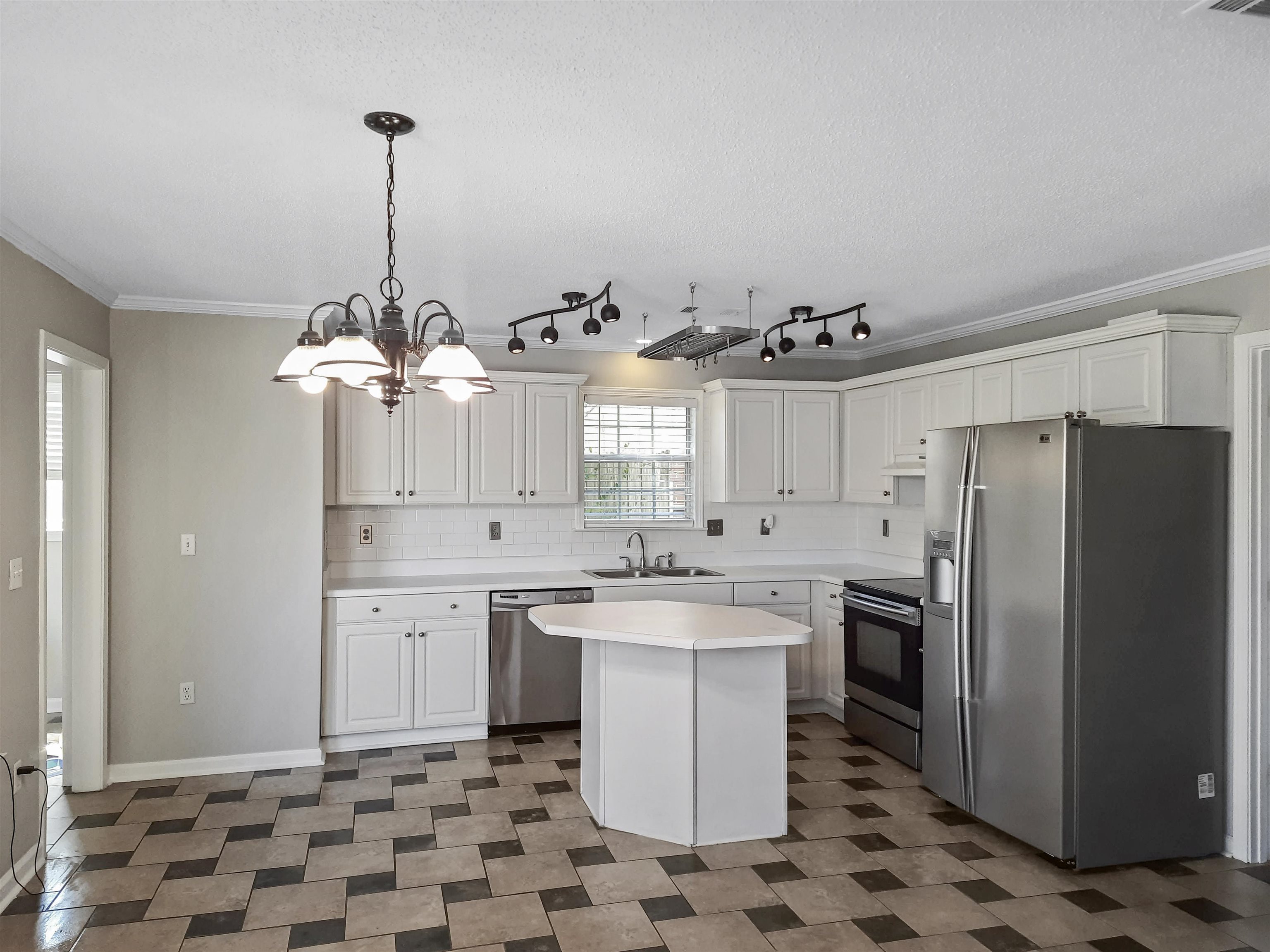 746 North Ericson Road Memphis, TN 38018 - Photo 6 of 17 Large kitchen includes eat-in dining, stainless steel appliances, and white cabinetry.