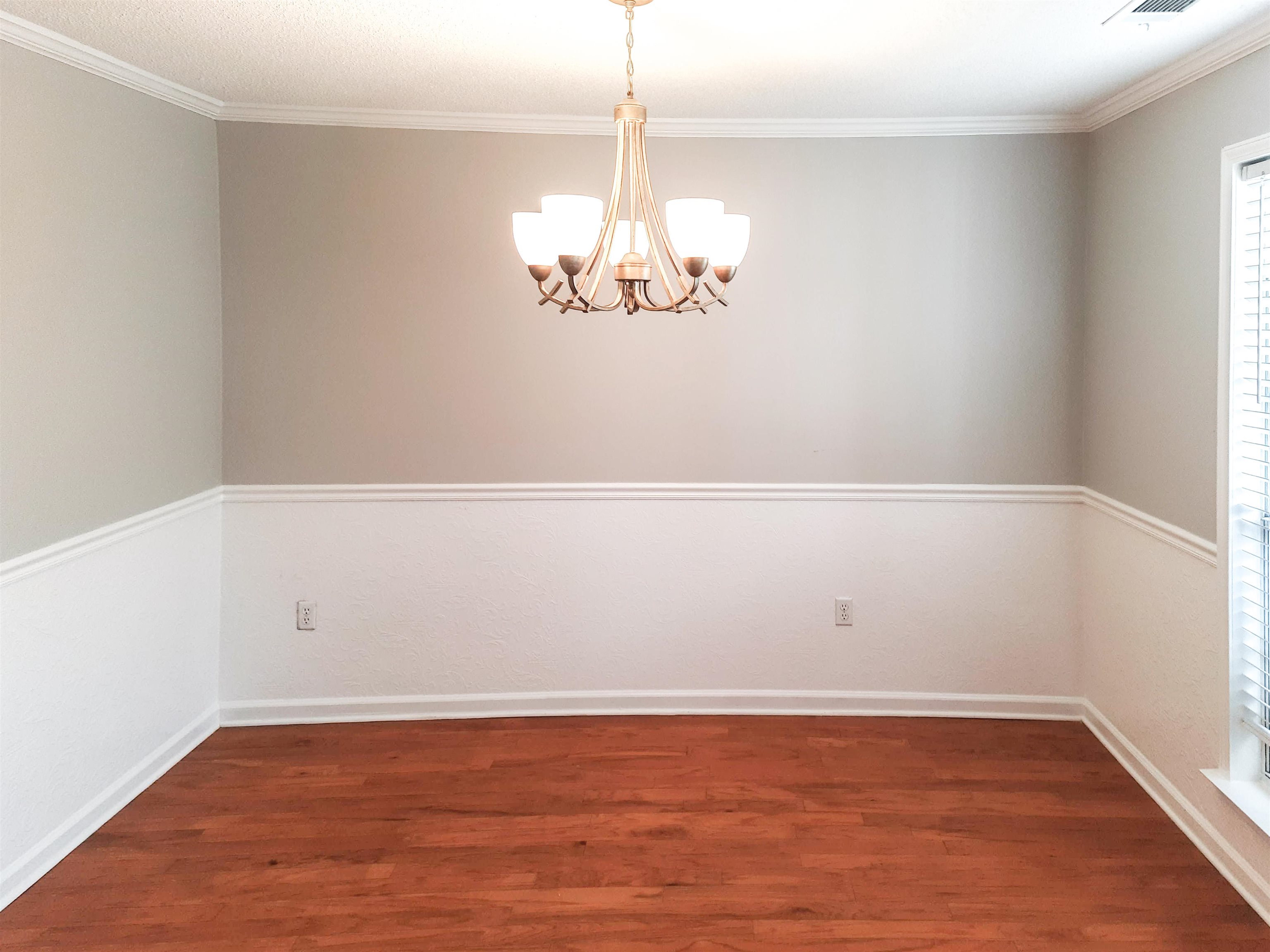 746 North Ericson Road Memphis, TN 38018 - Photo 10 of 17 Dining room features hardwood floors, chair railing, and custom panels.
