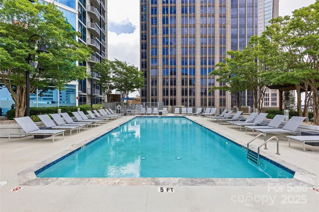 a front view of a house with swimming pool and sitting area