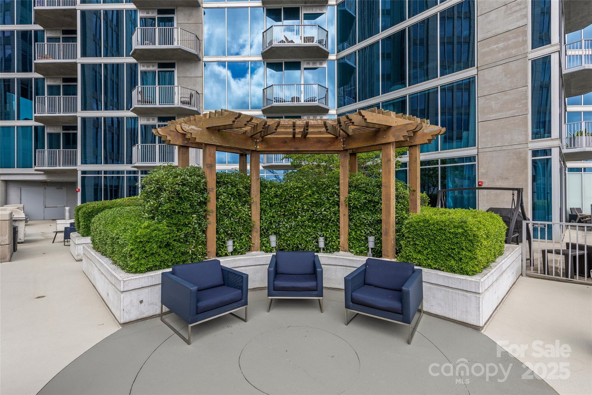 210 North Church Street, Unit 2910 Charlotte, NC 28202 - Photo 28 of 30 a view of a patio with a table and chairs under an umbrella