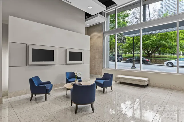 a living room with furniture tv and a window