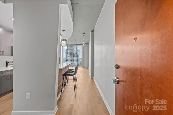 a view of a hallway with wooden floor and staircase